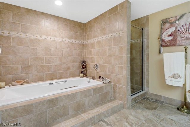 bathroom featuring separate shower and tub and tile walls