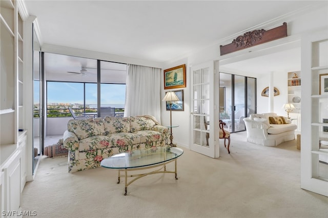 carpeted living room featuring a ceiling fan and french doors