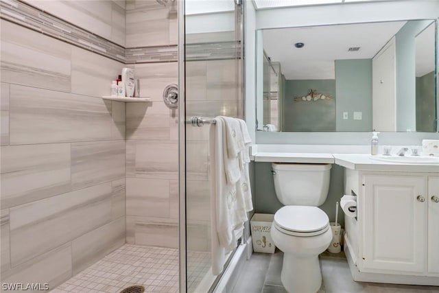 bathroom featuring a stall shower, visible vents, vanity, and toilet