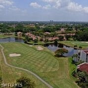 aerial view with a water view and golf course view