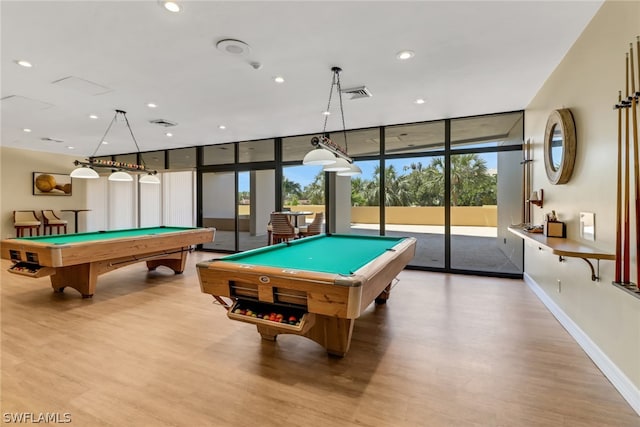 game room with a wall of windows, billiards, and hardwood / wood-style floors