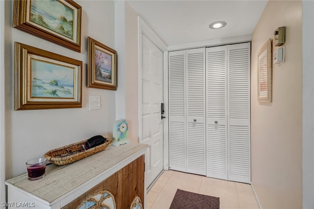 doorway to outside with light tile patterned floors