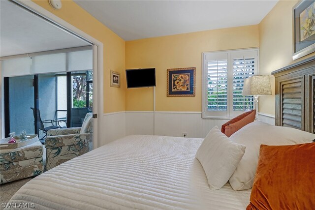 bedroom featuring multiple windows and access to outside