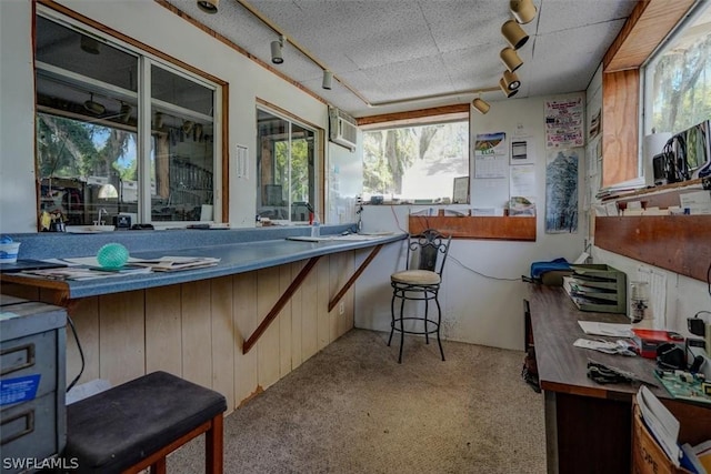 interior space featuring a bar and a wall unit AC