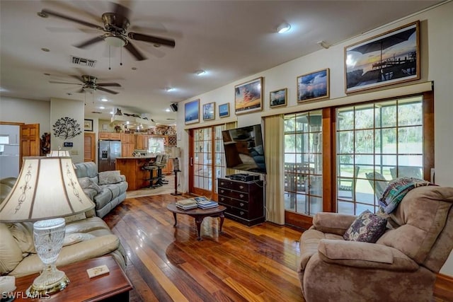 living room with dark hardwood / wood-style floors and ceiling fan