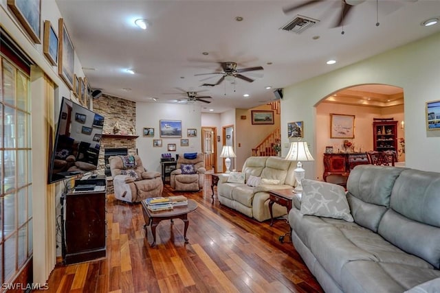 living room featuring hardwood / wood-style floors, a fireplace, and ceiling fan