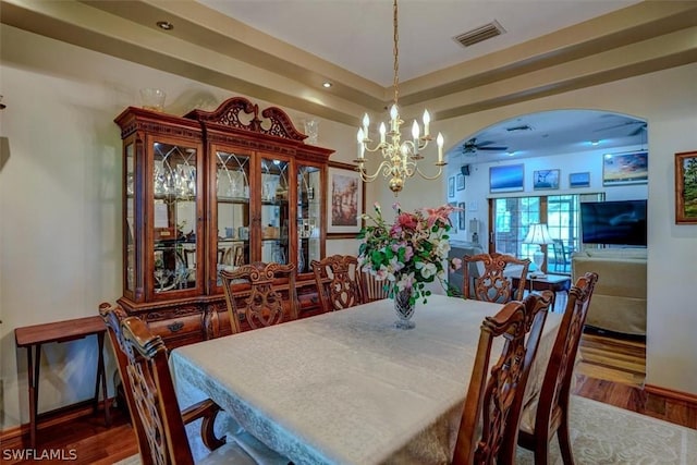 dining space featuring a notable chandelier and hardwood / wood-style flooring