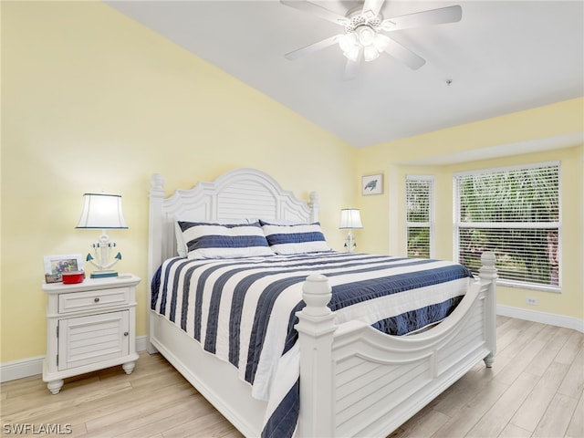 bedroom featuring ceiling fan, lofted ceiling, and light hardwood / wood-style flooring