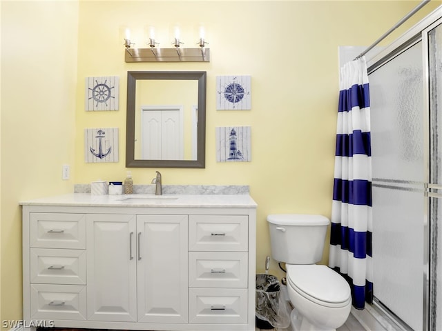 bathroom with vanity, toilet, and walk in shower