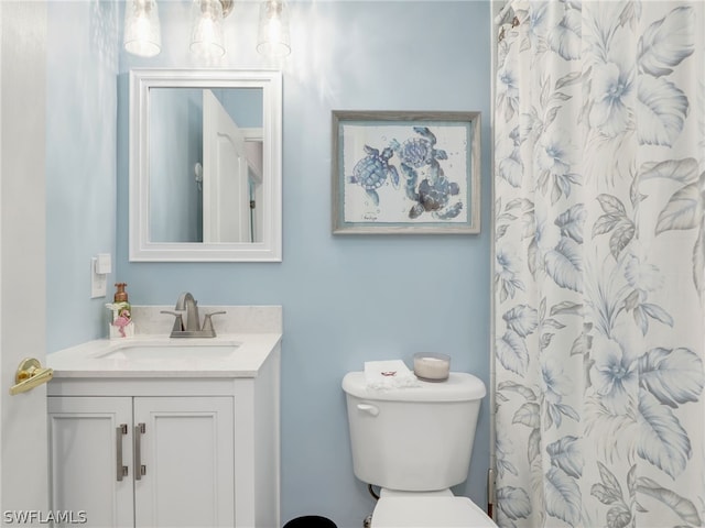 bathroom with vanity, toilet, and walk in shower