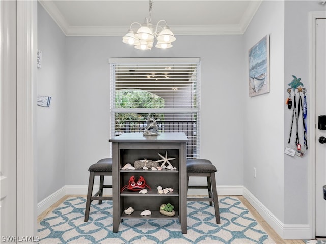 dining area with an inviting chandelier, light wood-type flooring, and ornamental molding