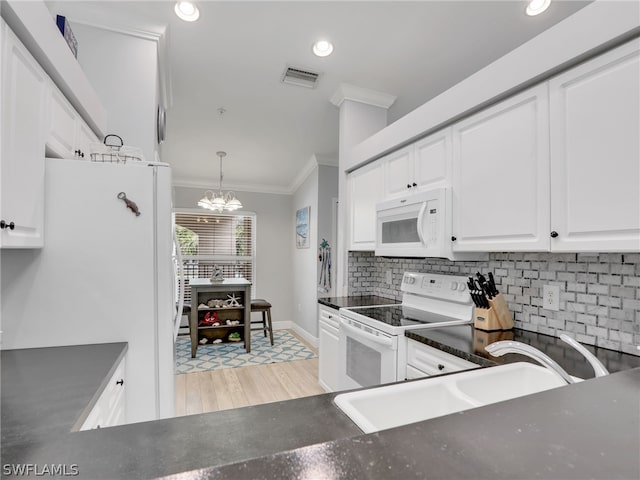 kitchen with white cabinets, pendant lighting, white appliances, and an inviting chandelier