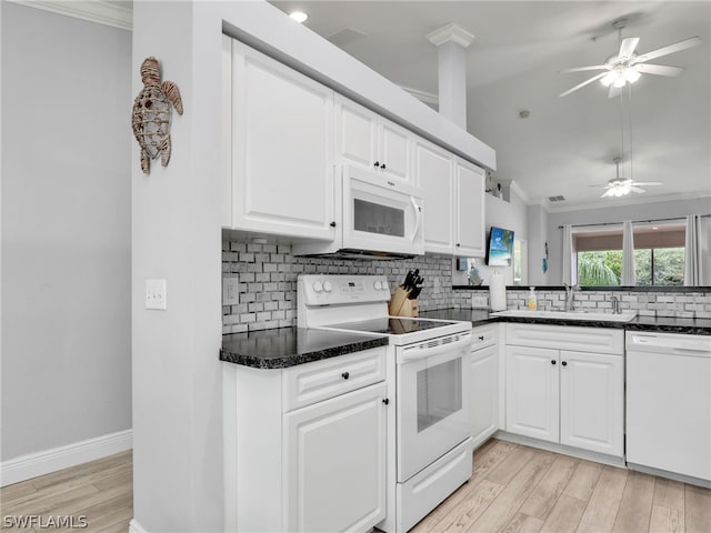 kitchen featuring white cabinetry, sink, light hardwood / wood-style flooring, white appliances, and decorative backsplash