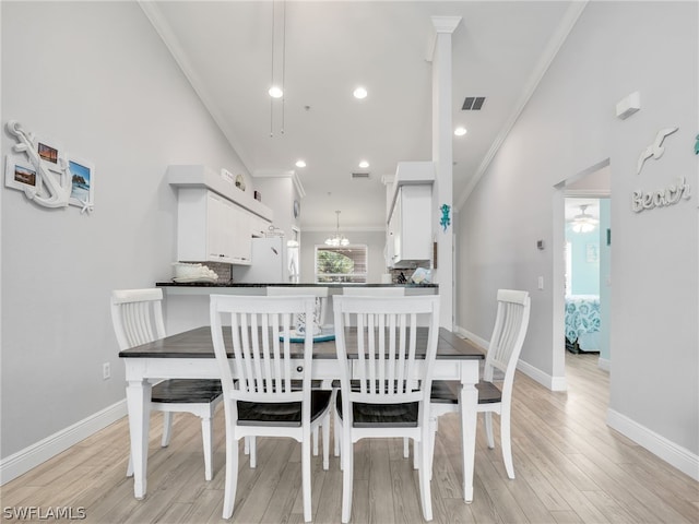 dining space featuring light hardwood / wood-style flooring, ceiling fan, and crown molding