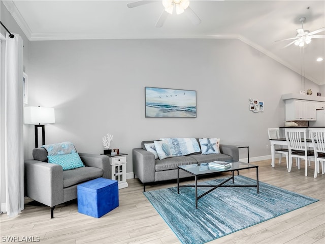 living room featuring light hardwood / wood-style flooring, vaulted ceiling, ceiling fan, and ornamental molding