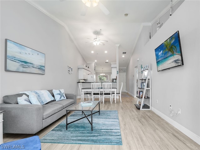 living room featuring light wood-type flooring, ceiling fan, and crown molding