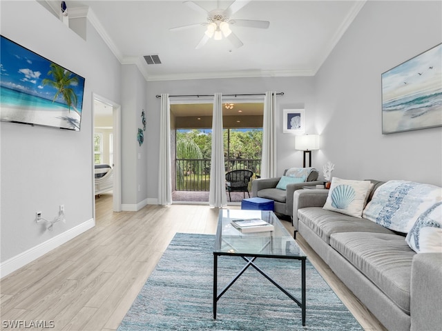 living room featuring ceiling fan, light wood-type flooring, and ornamental molding