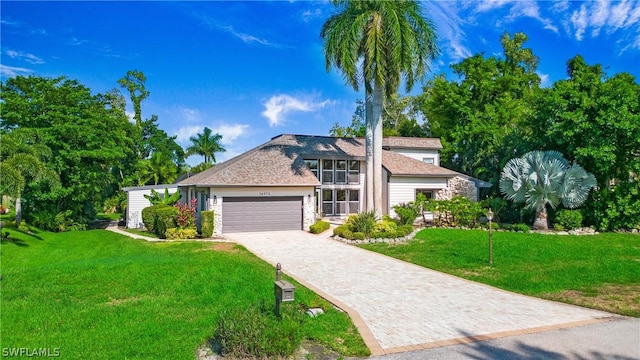 view of front facade with a front yard and a garage