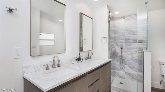 bathroom featuring vanity, toilet, and walk in shower