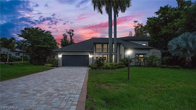 view of front facade with a lawn and a garage