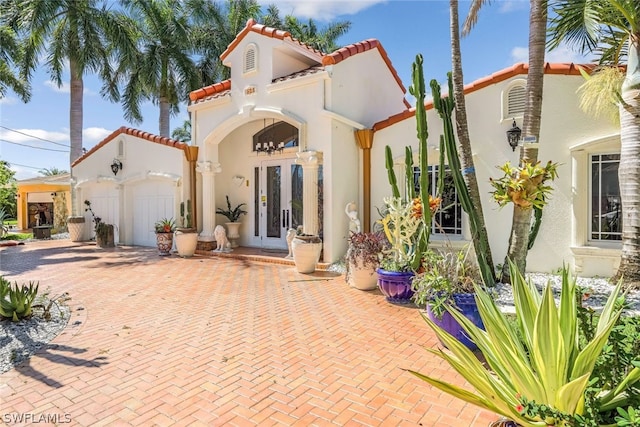 view of front of home with french doors and a garage