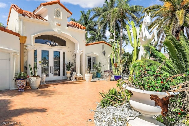 rear view of property featuring french doors and a patio