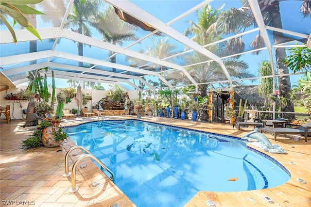 view of pool featuring glass enclosure and a patio area