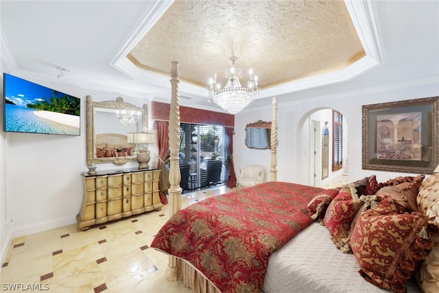 bedroom featuring a textured ceiling, crown molding, a tray ceiling, and a notable chandelier