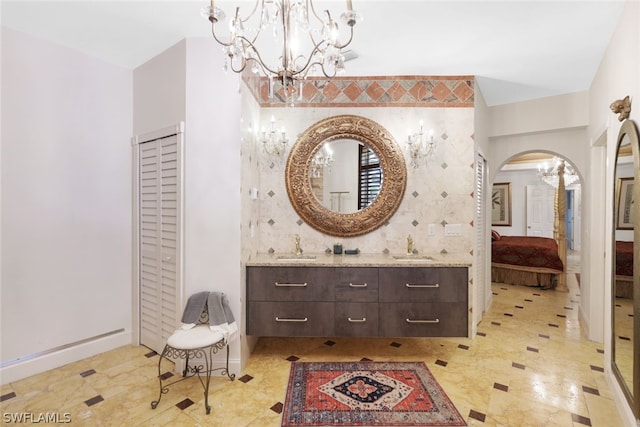 bathroom featuring vanity and a notable chandelier