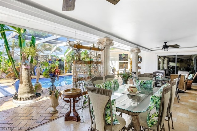 sunroom featuring decorative columns and ceiling fan