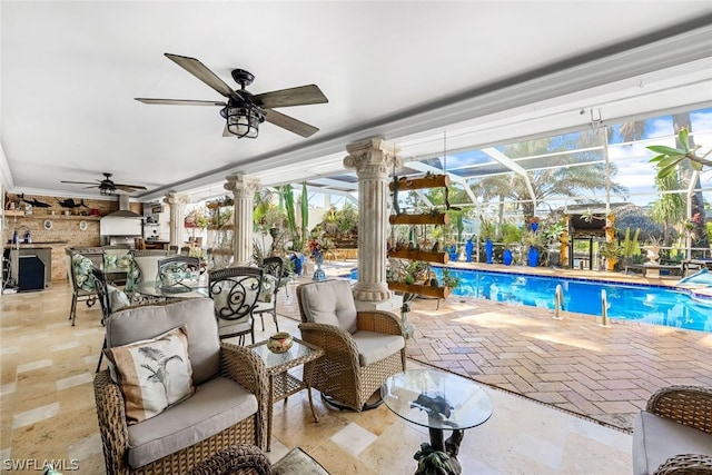 view of swimming pool featuring a lanai, a patio area, and exterior kitchen