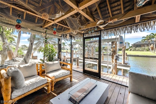 sunroom featuring a water view