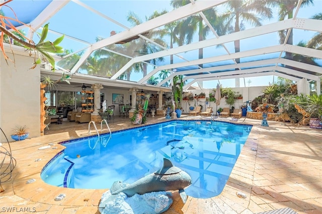 view of swimming pool featuring a patio area, a lanai, and ceiling fan