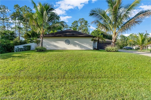 view of side of home with a lawn