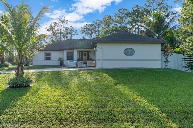 rear view of property with a patio and a lawn