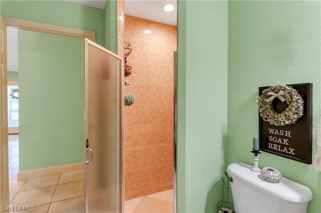 bathroom featuring toilet, walk in shower, and tile patterned floors