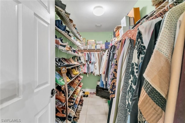 spacious closet with light tile patterned floors