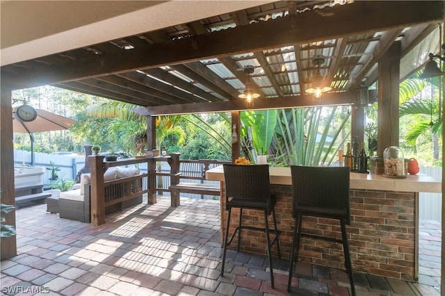 view of patio / terrace with a bar, a pergola, and outdoor lounge area