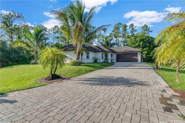 ranch-style home with a front yard and a garage