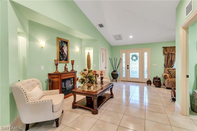 sitting room with lofted ceiling and light tile patterned floors