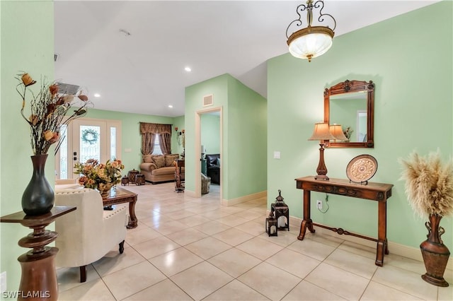 hallway featuring french doors and light tile patterned floors