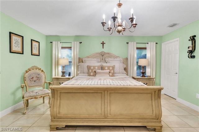 tiled bedroom featuring a notable chandelier