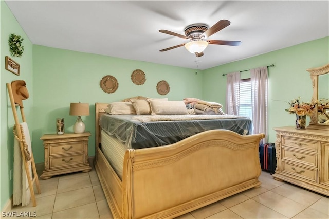 tiled bedroom featuring ceiling fan