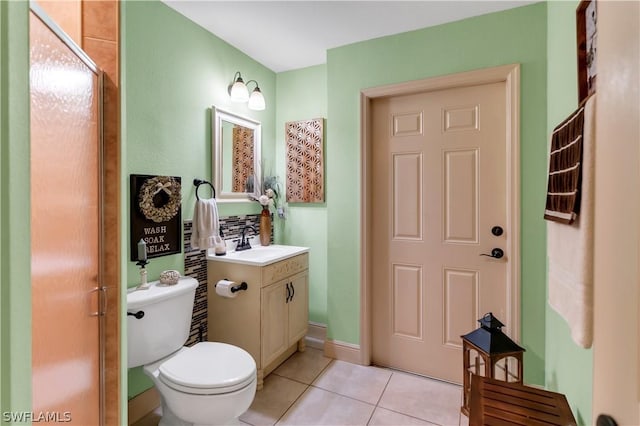 bathroom with tile patterned flooring, vanity, and toilet