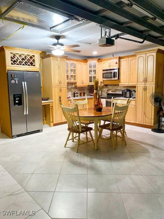 tiled dining area with ceiling fan