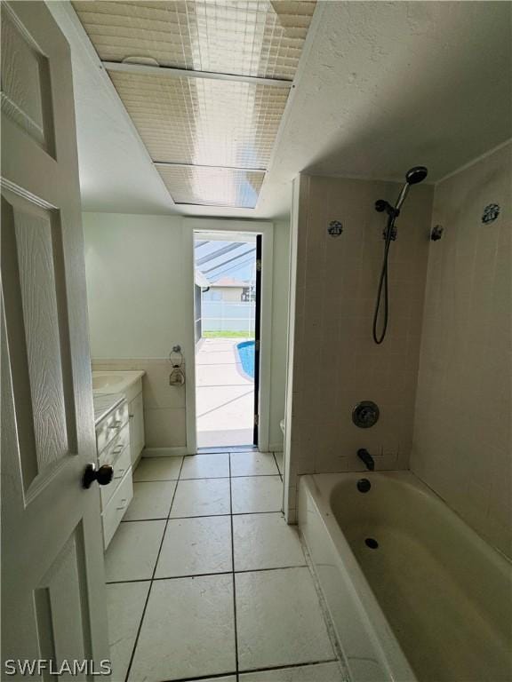 bathroom featuring tile patterned floors, vanity, and tiled shower / bath combo