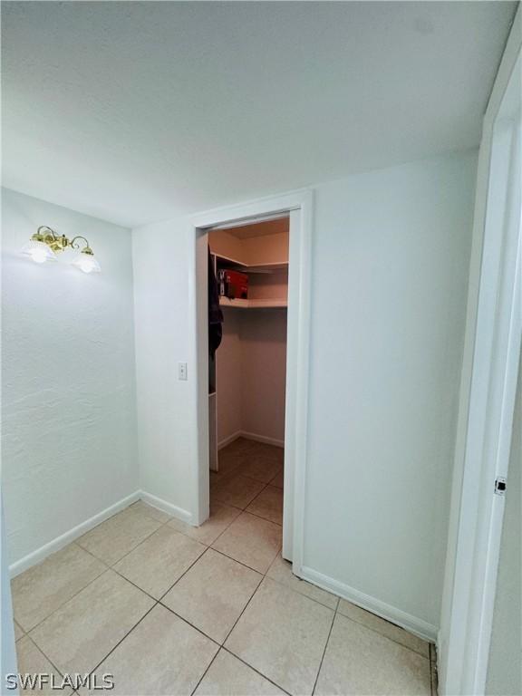 hall with light tile patterned floors