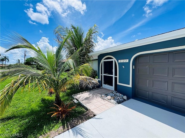 view of exterior entry with a garage