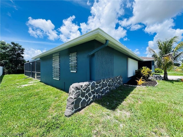 view of home's exterior with a lawn and a sunroom