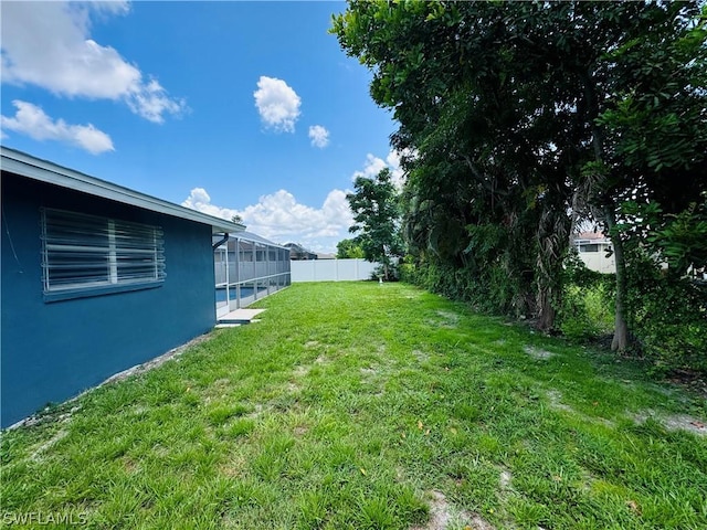 view of yard with a lanai